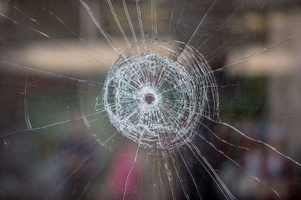 gun violence - bullet hole in a window